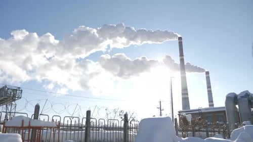 Industrial Plant With Smokestacks Releasing Plumes of Smoke