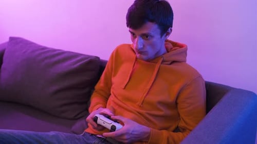 Man Playing Video Game on a Couch