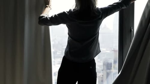 Woman Unveil Curtain And Admire View From Window At Home