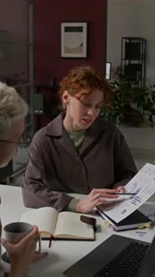 Young Man and Woman Discussing Charts