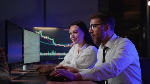 Man and Woman Celebrating Corporate Success in Office