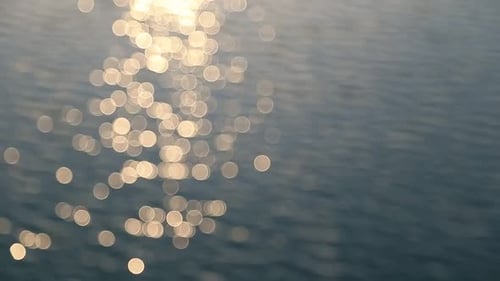 Abstract Motion of the Sunset Sea Shimmering Water Defocused Background Bokeh Effect