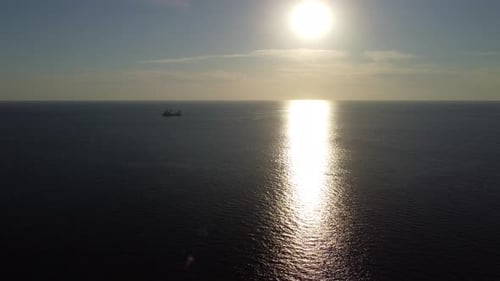 Aerial View of a Ferry Cargo Ship Sailing in the Calm Sea Ocean at Sunset Ideal for Maritime Travel