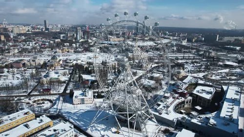 Beautiful urban landscape with Ferris wheel in city center in winter. Ferris wheel in center city