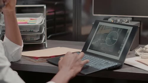 Hands Typing on Laptop in Office Setting