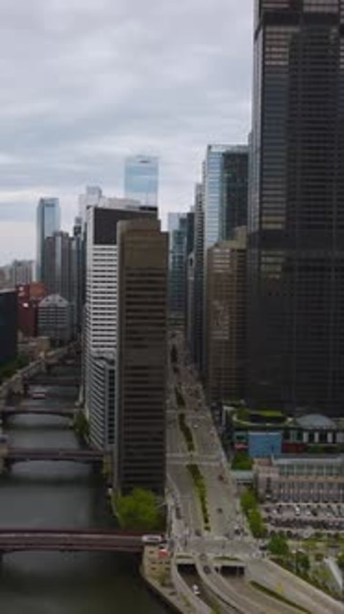 Approaching the row of high buildings separating Chicago River from wide busy multi-lane roads.
