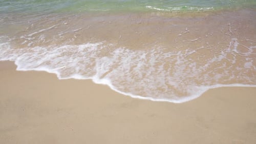 Sea waves splashing on a sand