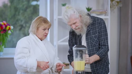 Mature Couple Preparing Drink in Blender at Home