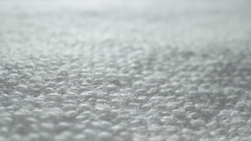 A close-up of a white, textured fabric.