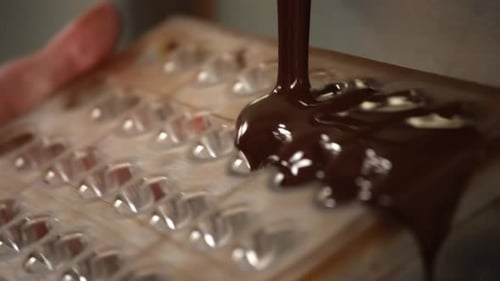 Pouring melted onto a bar, rich texture visible, close shot, indulgent mood