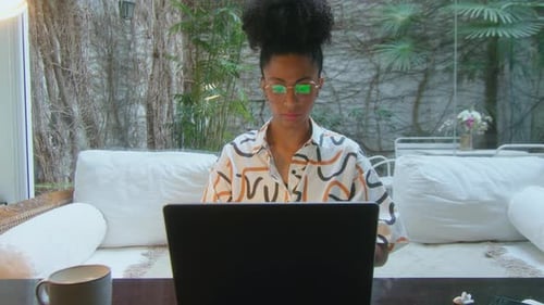 Young Black Woman Working on Laptop at Home Office