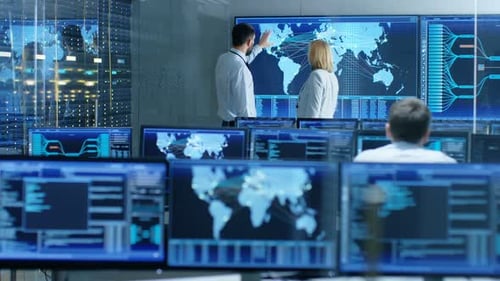 In the System Monitoring Room Two Senior Operators Work on a Big Interactive Map. Facility is Full
