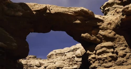 Natural Stone Arch Formation Under Clear Blue Sky at Rugged Canyon
