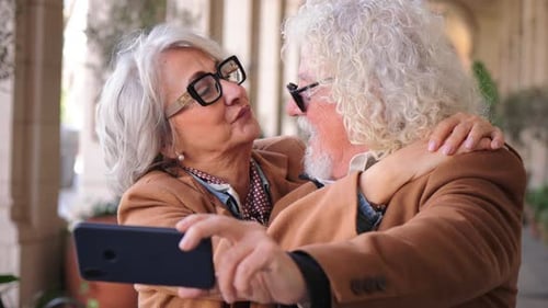 Senior Couple Embracing While Taking a Selfie