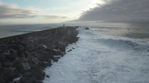 Ocean Waves Crashing on Rocky Pier from Above