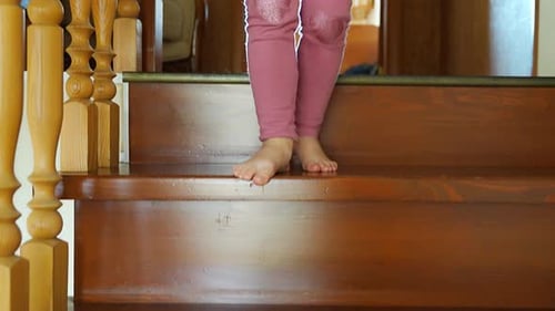 Child Barefoot Walking Down Polished Wooden Stairs