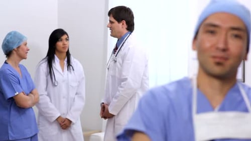 Smiling Surgeon With Colleagues in the Hospital