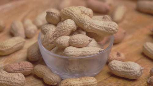 Peanuts in Glass Bowl on Wooden Table