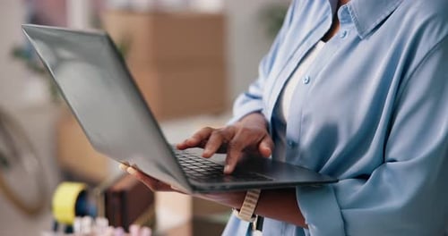 Woman Typing on Computer in Bright Office Setting