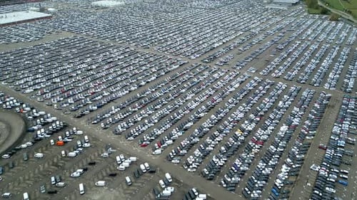 Many cars on a parking lot from above, filmed with a drone in 4k. high quality, thousand's of cars