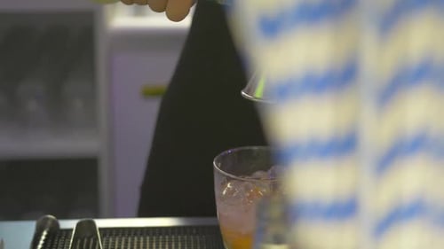 slow motion video of a barkeeper preparing a drink