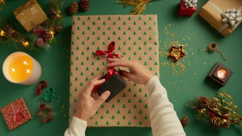 Top Down View Man Packing Christmas Gifts for Wife Friends and Relatives