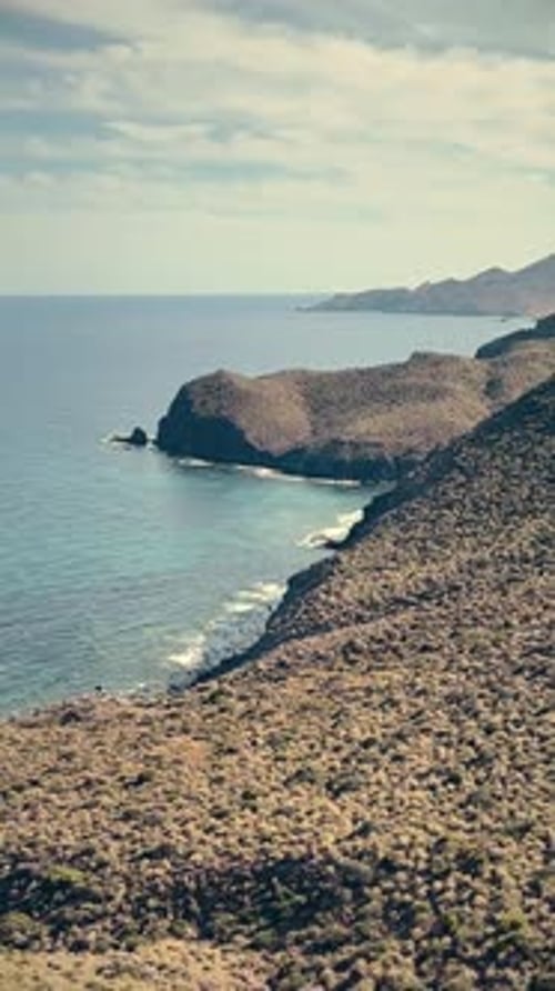 Vertical video of beach landscape, summer waves, paradise travel. South of Spain