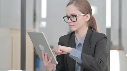 Young Professional Woman Using Tablet in Office
