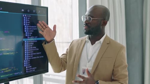 Confident Man Explains Programming Code in Office