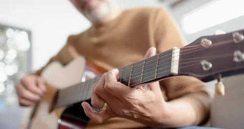 Senior Man Plays Acoustic Guitar Close Up