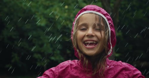 Laughing Child Enjoys Rain in Natural Setting