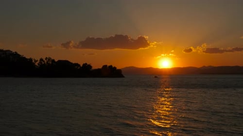 Orange sun reflected in open air bay.