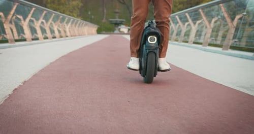 Close Up of Senior Man Riding Electric Mono Wheel Gyro Scooter Personal Electrical Transport City
