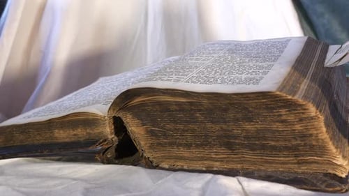 Old Bible book on altar, slider left