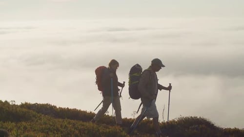 Mature Couple Hiking Raising Their Hands Up and Rejoicing