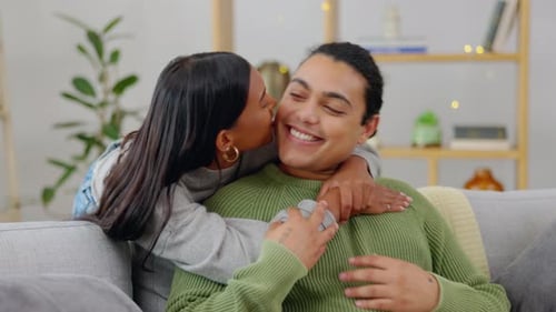 Affectionate Couple Embraces on Couch in Living Room