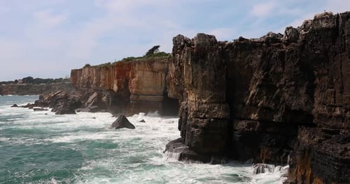 Majestic Coastal Cliffs Facing the Powerful Ocean Waves and Wind