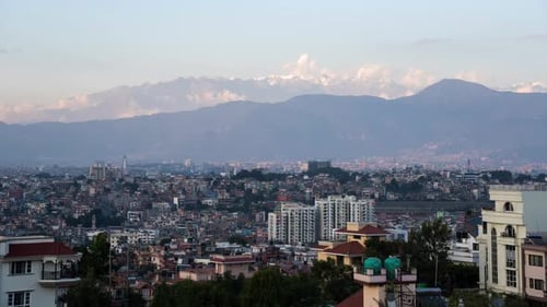 A day to night time-lapse of the sun setting over the city of Kathmandu, Nepal with the Himalaya Mou