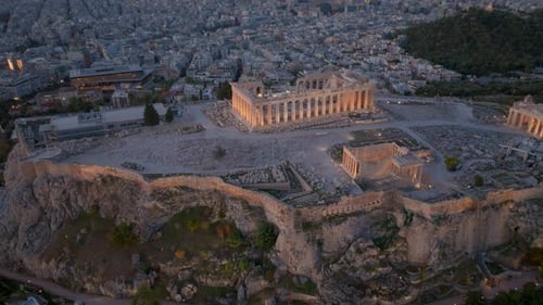 Descending pan up aerial shot of the lit up Acropolis Athens Greece