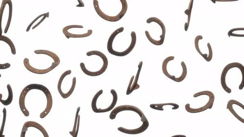 Lucky Horseshoes Falling on White Background