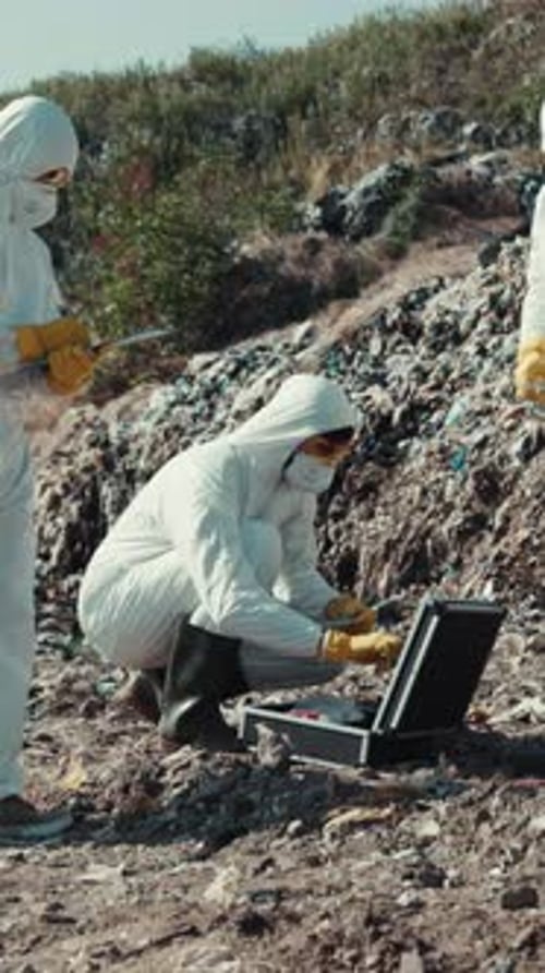 Scientists Study Garbage in White Protective Suits