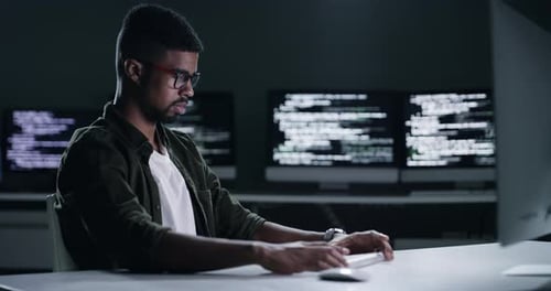 Young Adult Coding at Computer Late at Night