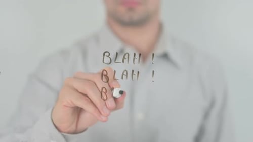 Blurred Person Writes 'Blah!' on Transparent Glass