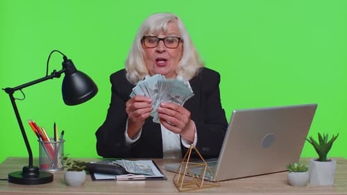 Senior Business Office Woman Analyzes Financial Charts Celebrate Success Win at Home Workplace Desk