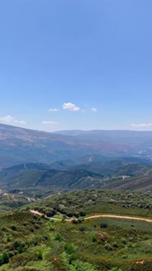 Vast rocky landscape covered with grasslands and tourist trails and roads.