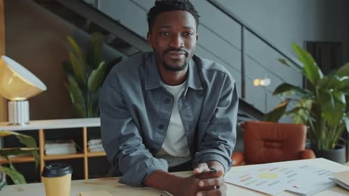 Portrait of Smiling African American Businessman in Casual Wear at Office Desk