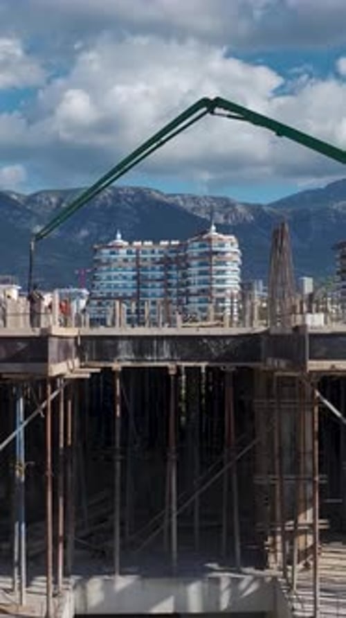 Vertical Video Concrete Being Poured for a Modern Residential Building Foundation on a Vibrant
