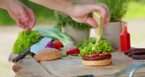 Preparing a Delicious Burger with Fresh Ingredients