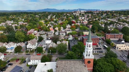 Small town America. USA city during autumn fall foliage in New England. Church steeple, colorful tre