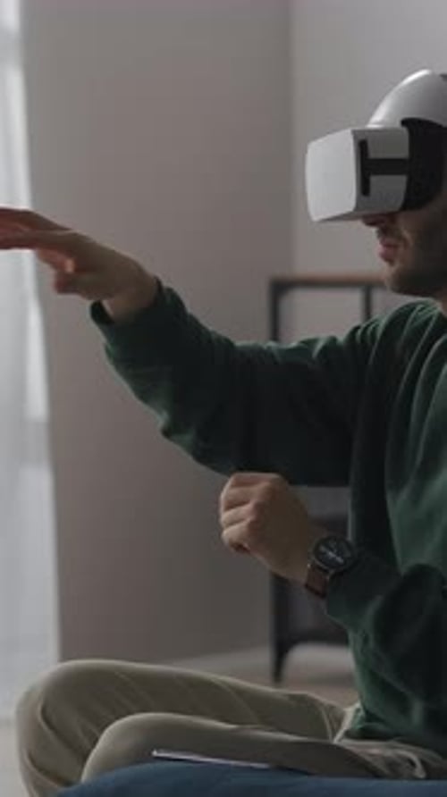 Man Immersed in VR Experience at Home